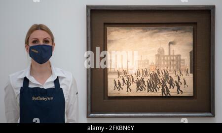 Sotheby’s, London, UK. 30 April 2021. The earliest known sports painting of Crowds Gathering for a Rugby Match in 1928 by L.S. Lowry is unveiled at Sotheby’s and will be auctioned at Sotheby’s London in summer, estimate £2,000,000-3,000,000. The work is on view for the first time in half a century. Credit: Malcolm Park/Alamy Live News. Stock Photo