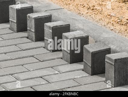 Laying floor tile sidewalk urban road or repairing paving stone slabs at a construction site. Stock Photo