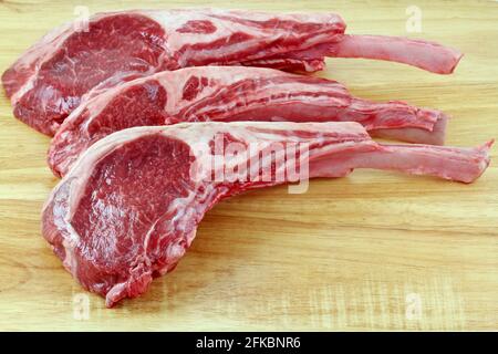 Closeup photo of fresh Lamb chops on a wooden cutting board Stock Photo