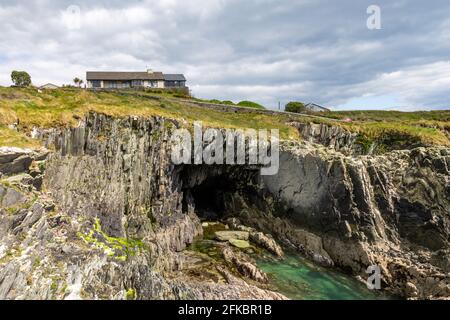 House above coastal cave, West Cork,Ireland Stock Photo