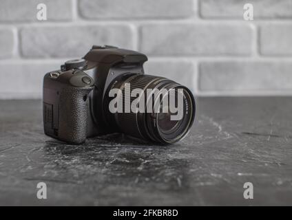 Russia, Krasnodar - April 2, 2021: Old Worn Canon 500D SLR Camera with 18-55mm Whale Lens Stock Photo