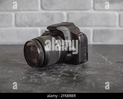 Russia, Krasnodar - April 2, 2021: Old Canon Rebel T1i or 500D Amateur SLR Camera with 18-55mm Whale Lens Stock Photo