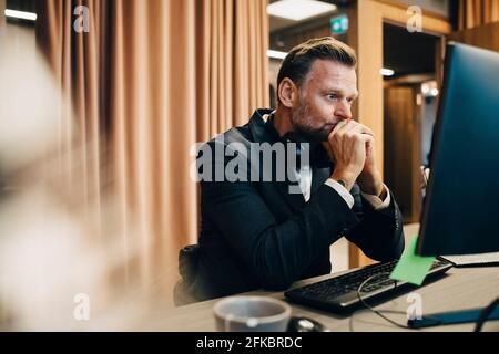 Worried businessman working on computer in office Stock Photo