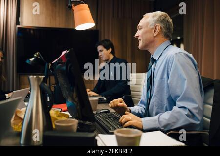 Male entrepreneurs working in board room at office Stock Photo