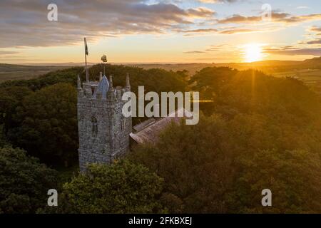 St. Dennis Parish Church emerging from trees at sunrise in autumn, St. Dennis, Cornwall, England, United Kingdom, Europe Stock Photo