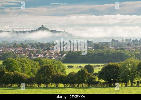 View across the town of Street towards Glastonbury Tor on a misty autumn morning, Somerset, England, United Kingdom, Europe Stock Photo