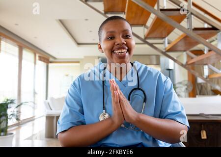 African american female doctor giving video call consultation looking at camera Stock Photo