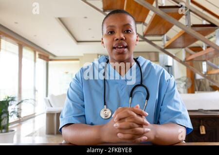 African american female doctor giving video call consultation looking at camera Stock Photo