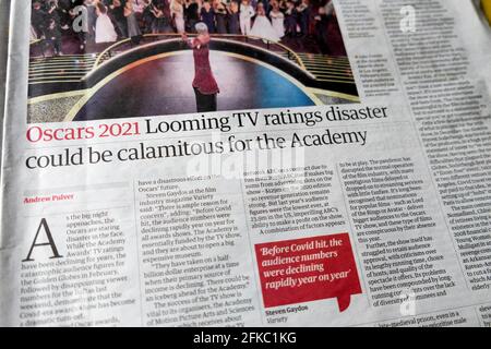 'Oscars 2021 Looming TV ratings disaster could be calamitous for the Academy' Guardian newspaper headline inside article 17 April 2021 London UK Stock Photo