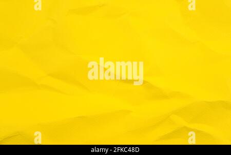 Vivid colorful wrinkled crumpled calendula, marigold yellow blank paper texture abstract background. Stock Photo
