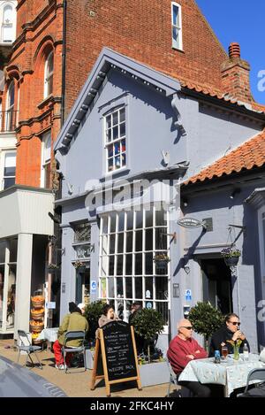 Eating outside the Aldeburgh Market, on the pretty High Street, in Suffolk, East Anglia, UK Stock Photo