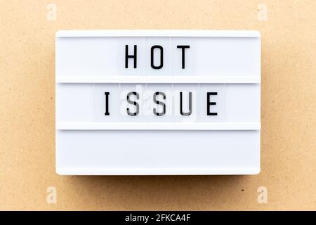 Light box with word hot issue on wood background Stock Photo