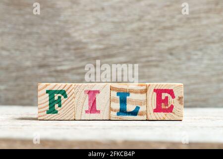 Letter block in word file on wood background Stock Photo