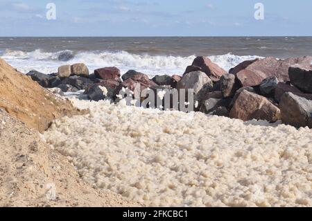 Sea foam building up behind rock armour at Happisburgh, north Norfolk  England UK Stock Photo - Alamy