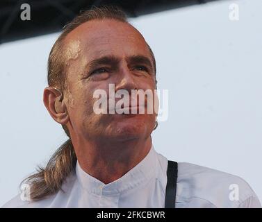 STATUS QUO'S  FRANCIS ROSSI ON STAGE ABOARD HMS ARK ROYAL AT PORTSMOUTH WHERE THE BAND PERFORMED FOR THE CREW TO LAUNCH THEIR NEW ALBUM. PIC MIKE WALKER, 2002 Stock Photo