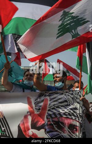 Beirut, Lebanon. 30th Apr, 2021. Pro-Iranian Hezbollah supporters wave the flags of Palestine and Lebanese Resistance Brigades during a rally in solidarity with Palestinians in Jerusalem and the West Bank in front of the United Nations (ESCWA) building. Credit: Marwan Naamani/dpa/Alamy Live News Stock Photo