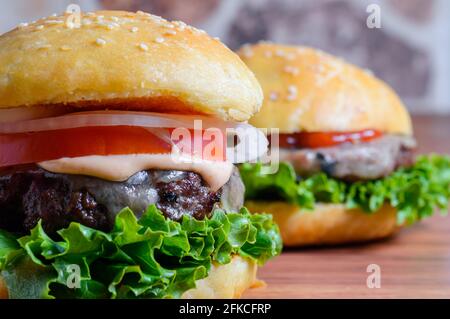 Home made barbecue cheese burgers in brioche bread buns Stock Photo