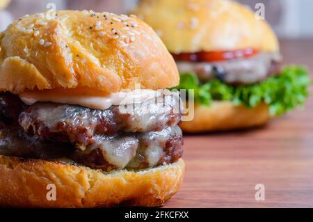 Home made barbecue cheese burgers in brioche bread buns Stock Photo