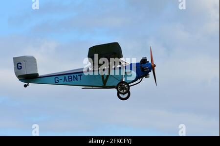 Vintage 1931 Civilian Coupe 02 G-ABNT  aircraft in flight  with blue sky and clouds. Stock Photo