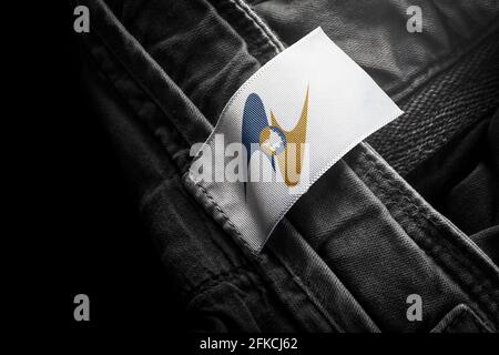 Tag on dark clothing in the form of the flag of the Eurasian Economic Union Stock Photo