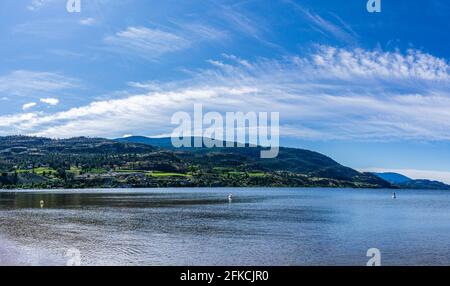 PENTICTON, CANADA - JULY 04, 2020: beautiful Skaha lake with blue sky and white clouds summer morning. Stock Photo