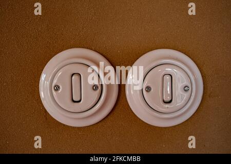 A pair of old switches on the wall with clay plaster Stock Photo