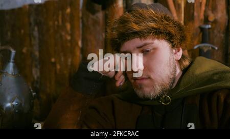 Portrait of man in russian ethnic suit playing chess Stock Photo