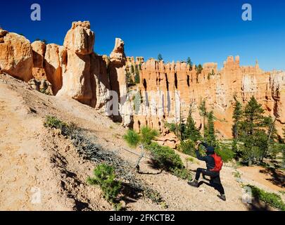 Hiker taking a picture in Bryce National Park, Utah, USA. Stock Photo