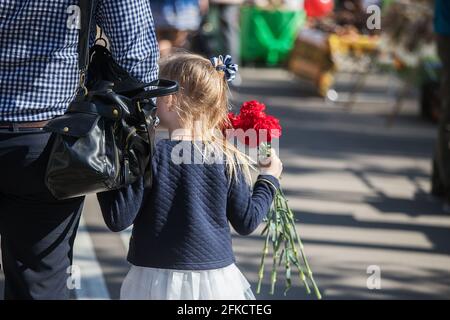 military holiday in city, parade of armed forces of country a solemn March through streets of city, soldiers in uniform clearly stamping step in colum Stock Photo