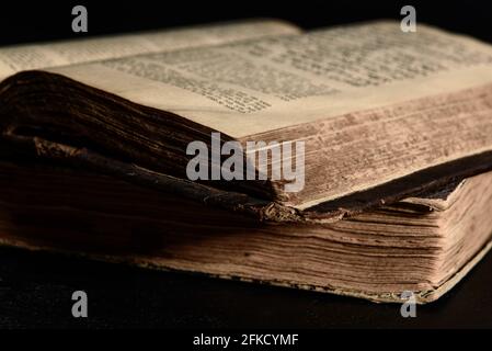 Jewish Bible. Old worn Jewish books. Opened scripture pages. Selective focus. Closeup Stock Photo