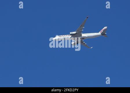 Stockholm, Sweden - April 30, 2021: Low angle view of Qatar Airways Airbus A350-941 airliner with registration A7-ALR in flight against a blue sky. Stock Photo