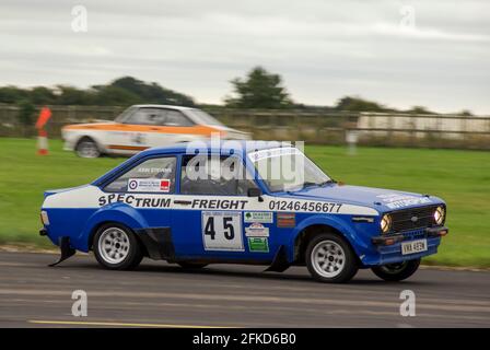 Richard Burns Memorial Rally 2009 at RAF Marham, Norfolk, UK, with a classic Ford Escort rally car driving at speed. Driver John Stevens Stock Photo