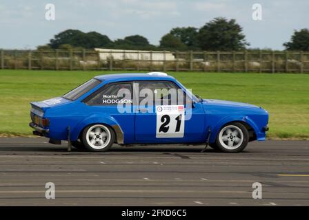 Richard Burns Memorial Rally at RAF Marham, Norfolk, UK, with a classic Ford Escort rally car driving at speed. Driver Martin Hodgson Stock Photo