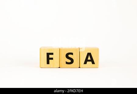 FSA, flexible spending account symbol. Concept word 'FSA, flexible spending account' on cubes on a beautiful white background. Business and FSA, flexi Stock Photo
