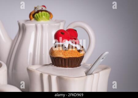 Decorative sugar bowl with muffin-shaped lid. Unusual dishes. White ceramic tableware Stock Photo