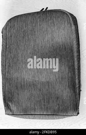 Close-up of beautiful gray-red laptop bag on white wooden background Stock Photo