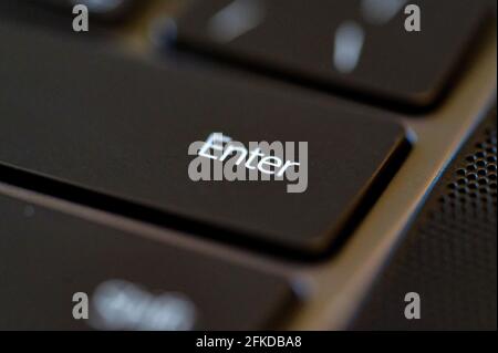 Close-up of keyboard enter key. Computer technology concept. Selective focus. Stock Photo