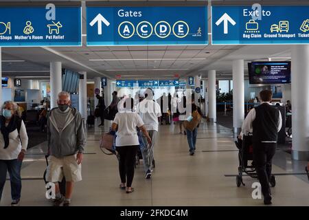 People walk through the B Councourse terminal at the Charlotte Douglas International Airport, Friday, April 30, 2021, in Charlotte, N.C. Stock Photo