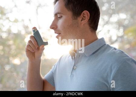 Man using inhaler Stock Photo