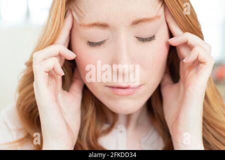 Woman with headache Stock Photo