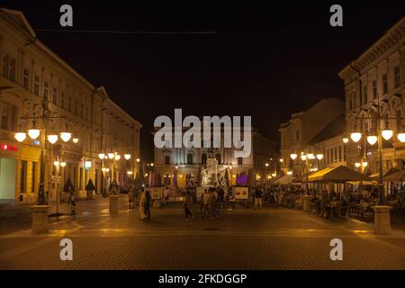 Picture of people walking by the statue of Kossuth Lajos, in a pedestrian street of the center in the city of Szeged, hungary. This city is the 3rd la Stock Photo