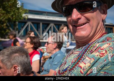 Tauranga New Zealand - April 2 2021; Enjoying the event, mature man with beads and colorful shirt smiles at National Jazz Festival Stock Photo