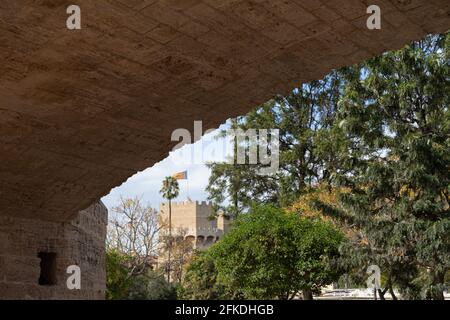 Ancient stone bridge across old riverbed, urban park. Puente de la Trinidad, Turia river, Valencia, Spain. Stone ashlars construction. Stock Photo