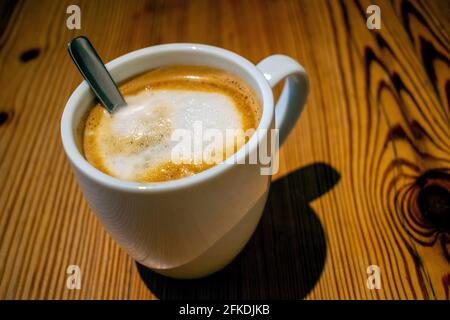 White coffee cup on wooden table. Stock Photo