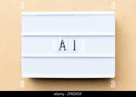 White lightbox with word AI (Abbreviation of artificial intelligence) on wood background Stock Photo