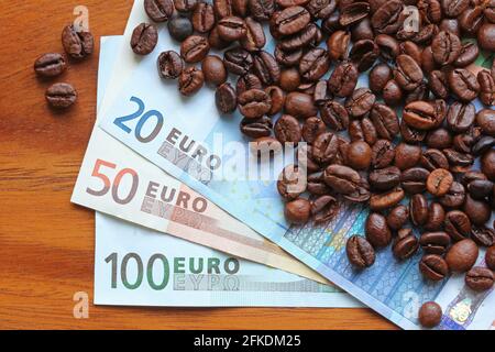 Coffee beans on top of Euro banknotes money Stock Photo