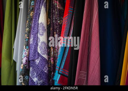 Close-up rows of pieces of fabric made of cotton, polyester, tapestry and other materials of different colors and prints for sewing curtains, handkerc Stock Photo