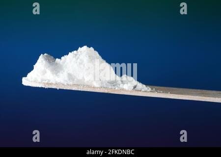 Closeup of white powder looking like drugs in front of a gradient background Stock Photo