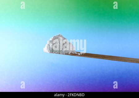 Closeup of white powder looking like drugs in front of a gradien background Stock Photo