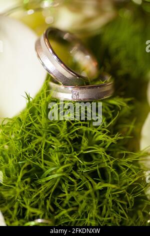 Close view on calla flowers with wedding rings in warm colors. High quality photo Stock Photo